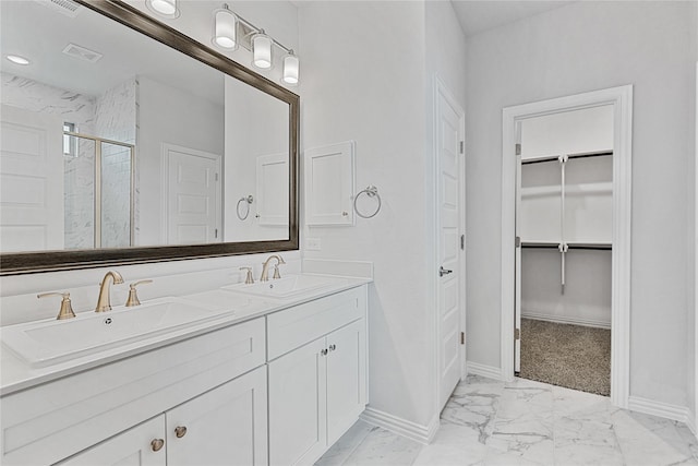 bathroom with marble finish floor, visible vents, a sink, and a marble finish shower