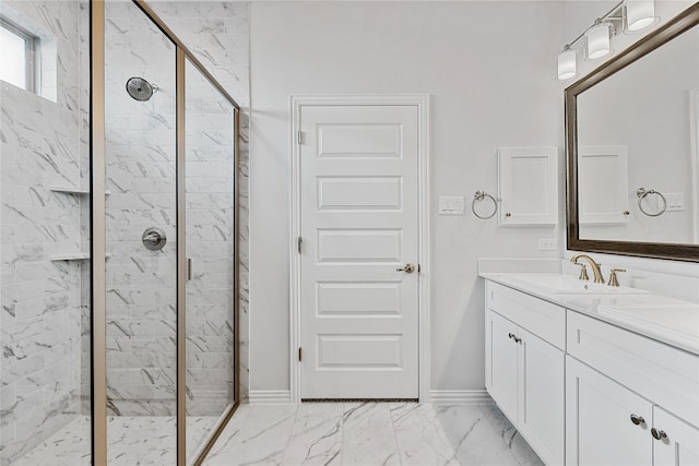 full bath featuring marble finish floor, a marble finish shower, baseboards, and vanity