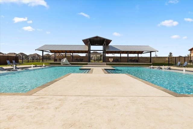 view of swimming pool with a fenced in pool, a patio, and fence