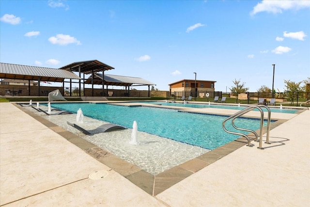 community pool with a gazebo, a patio area, and fence