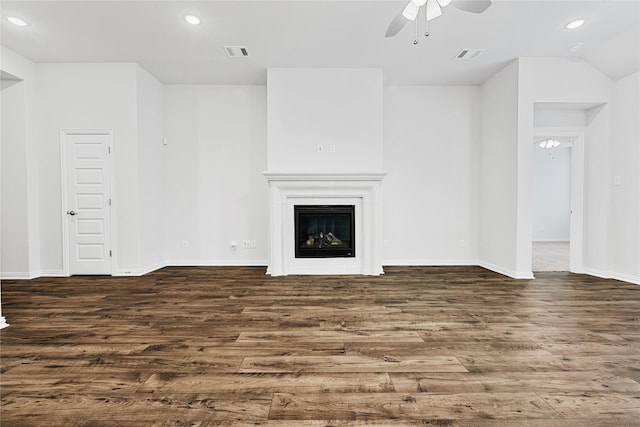 unfurnished living room with a fireplace, visible vents, wood finished floors, and recessed lighting