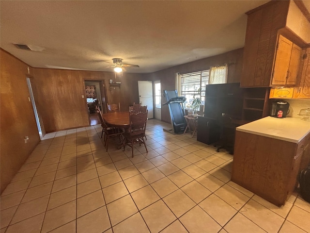 dining space with visible vents, a ceiling fan, and light tile patterned floors