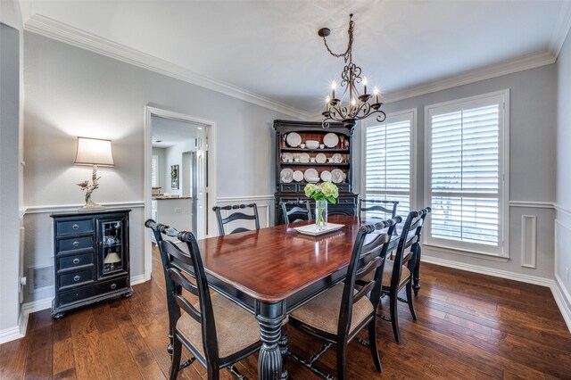 dining space featuring dark wood-type flooring, crown molding, and an inviting chandelier