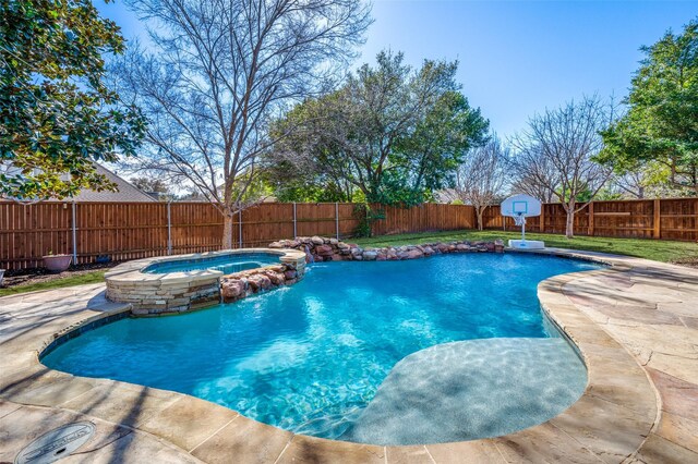 view of pool featuring a pool with connected hot tub and a fenced backyard