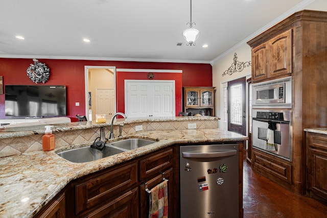 kitchen featuring stainless steel appliances, backsplash, ornamental molding, a sink, and light stone countertops