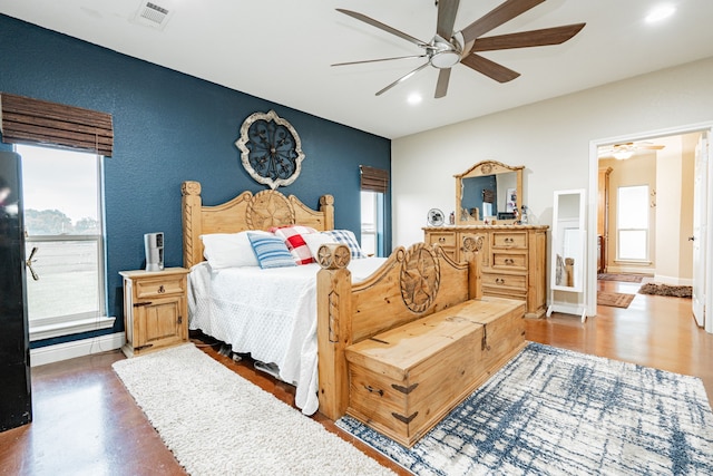 bedroom with visible vents, baseboards, and multiple windows