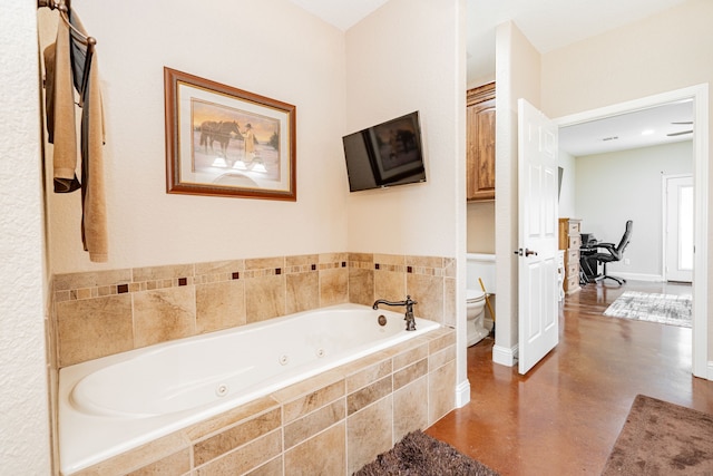 full bath with toilet, finished concrete flooring, baseboards, and a whirlpool tub