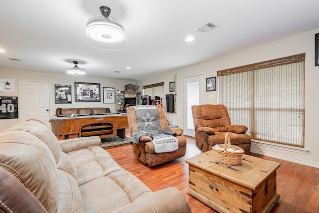 living room with visible vents, wood finished floors, and recessed lighting