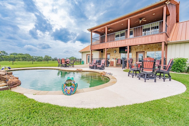 pool with a yard, a ceiling fan, a patio, and fence