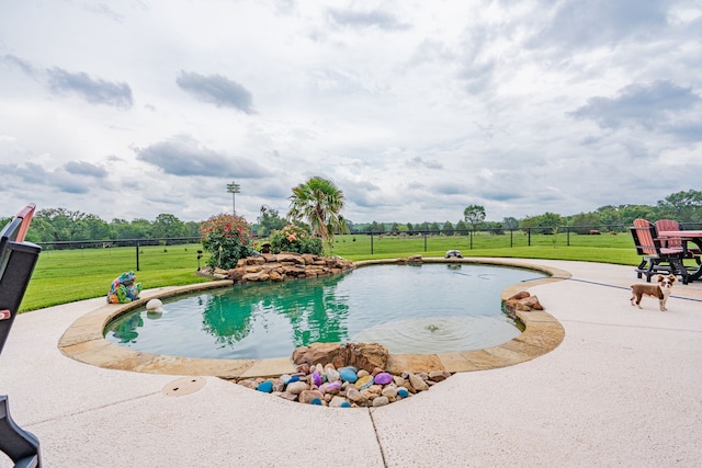 view of swimming pool featuring a lawn, a patio area, fence, and a fenced in pool