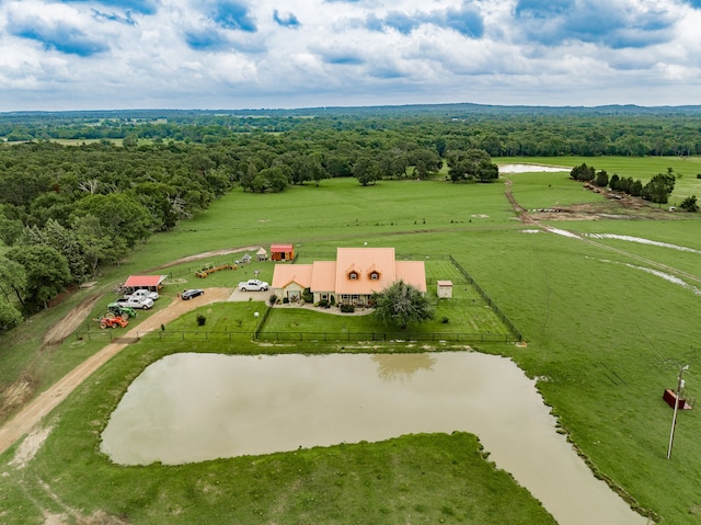 drone / aerial view with a rural view, a water view, and a view of trees