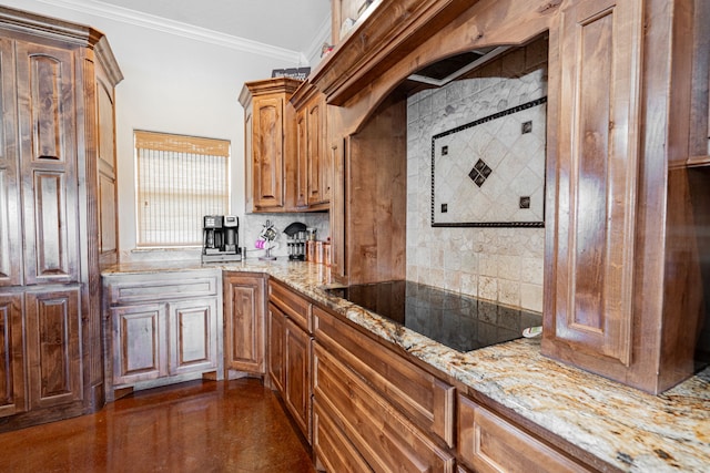 kitchen with tasteful backsplash, ornamental molding, black electric cooktop, and light stone counters