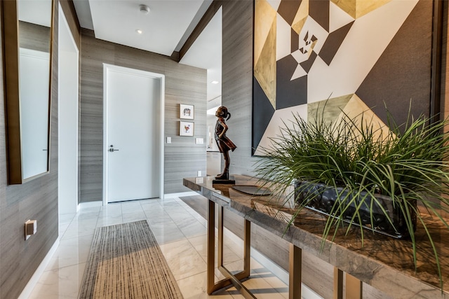 hallway featuring marble finish floor