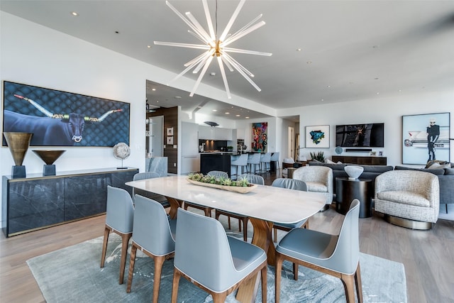 dining space featuring recessed lighting, a notable chandelier, and wood finished floors