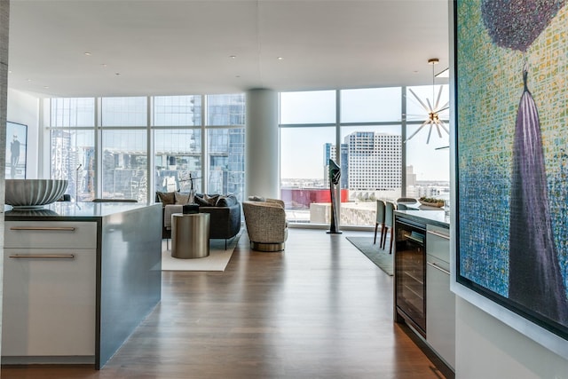 kitchen with expansive windows, beverage cooler, dark wood-type flooring, and open floor plan