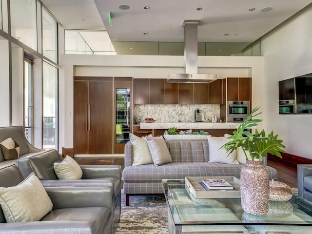 living area featuring dark wood finished floors and a high ceiling