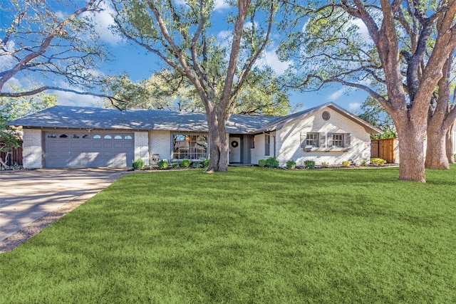 single story home with a garage, concrete driveway, brick siding, and a front yard