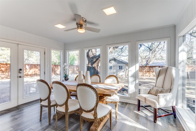 sunroom featuring a ceiling fan and french doors