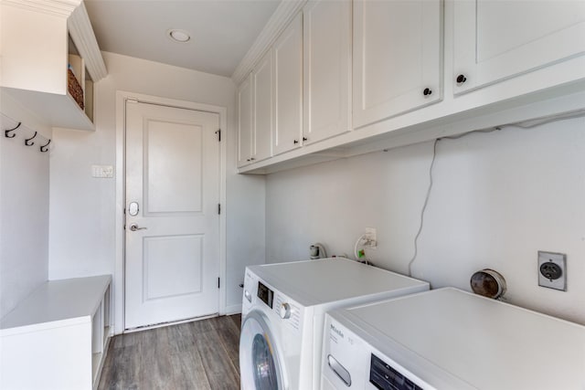 washroom featuring washer and clothes dryer, wood finished floors, and cabinet space