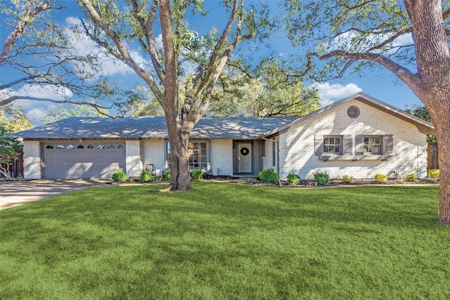 single story home with a garage, concrete driveway, brick siding, and a front lawn