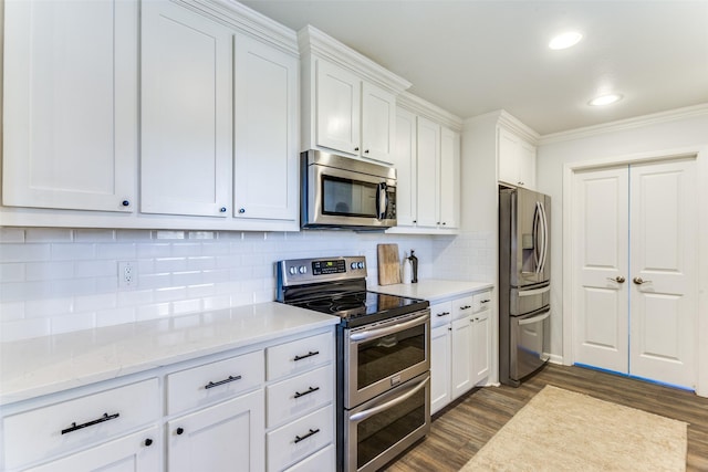 kitchen with dark wood-style floors, stainless steel appliances, backsplash, and white cabinetry