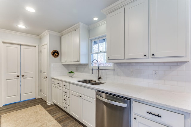 kitchen with dishwasher, dark wood-style flooring, crown molding, white cabinetry, and a sink