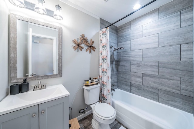 full bathroom featuring shower / tub combo, baseboards, vanity, and toilet