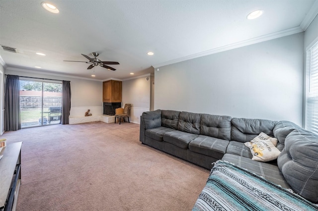 living area with recessed lighting, visible vents, ornamental molding, and light colored carpet