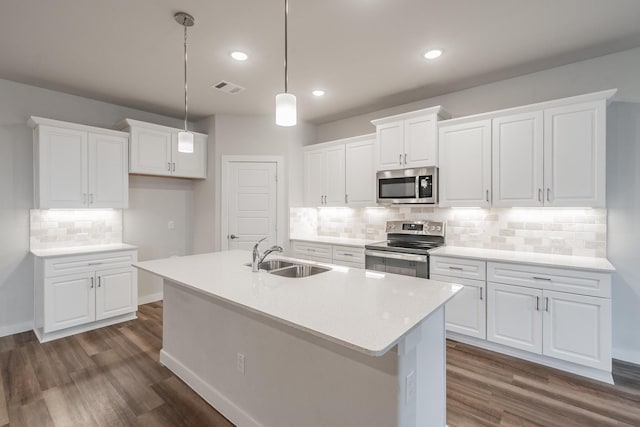 kitchen featuring a sink, visible vents, white cabinets, appliances with stainless steel finishes, and dark wood finished floors