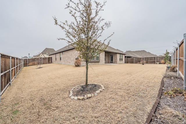 view of yard with a fenced backyard