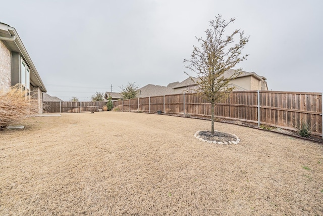 view of yard with a fenced backyard