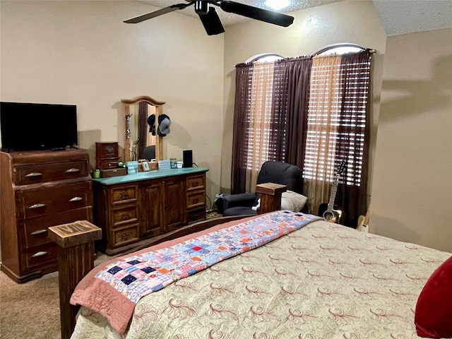 bedroom with ceiling fan, a textured ceiling, and carpet