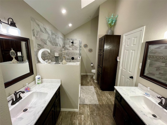 full bath featuring lofted ceiling, wood finished floors, a sink, and a walk in shower