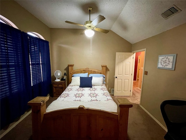 carpeted bedroom featuring visible vents, baseboards, ceiling fan, vaulted ceiling, and a textured ceiling