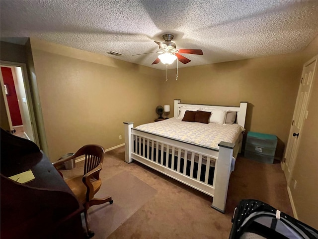 carpeted bedroom featuring a textured ceiling, baseboards, visible vents, and a ceiling fan