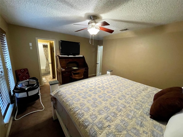 bedroom featuring a ceiling fan, visible vents, a textured ceiling, and carpet flooring