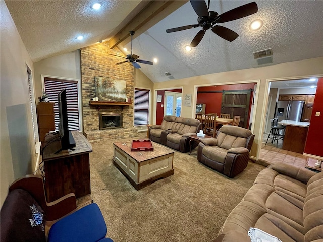 carpeted living room with lofted ceiling with beams, a fireplace, visible vents, and a textured ceiling