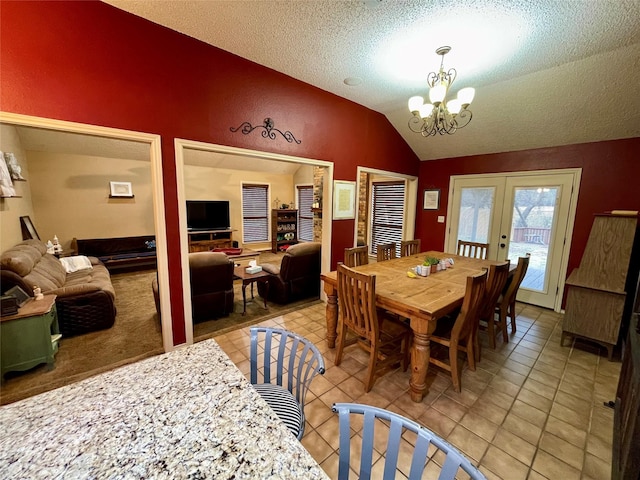 dining space featuring lofted ceiling, a textured ceiling, a chandelier, light tile patterned flooring, and french doors