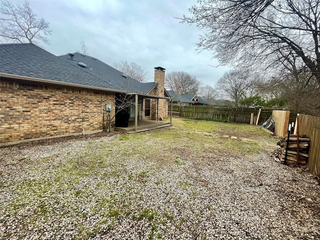 view of yard with a patio area and a fenced backyard