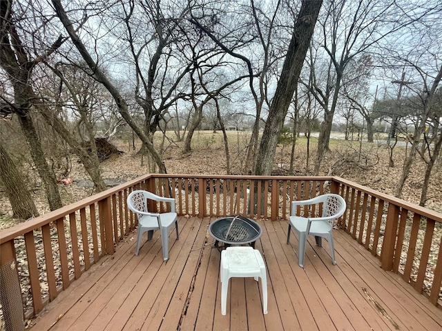 wooden terrace featuring a fire pit