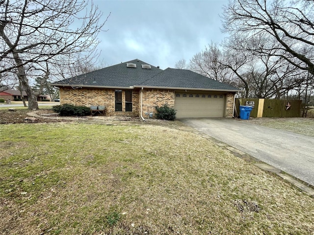 view of front of property with a shingled roof, a front yard, fence, a garage, and driveway