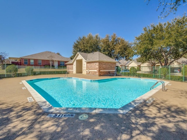 community pool with a patio and fence