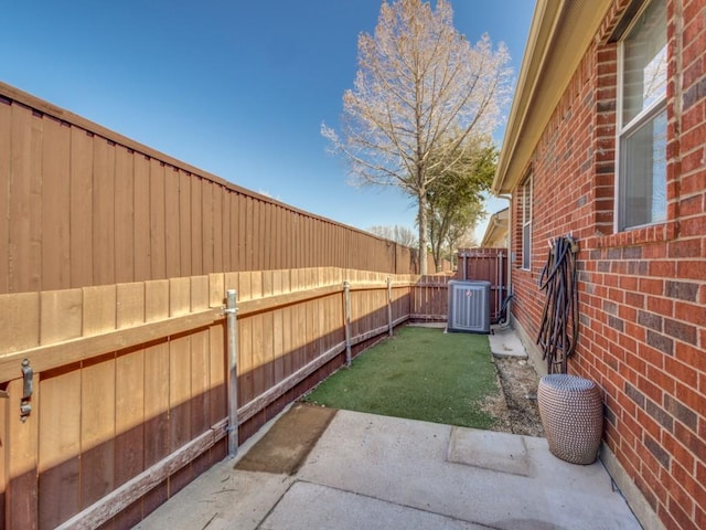 view of yard featuring a patio area, a fenced backyard, and cooling unit