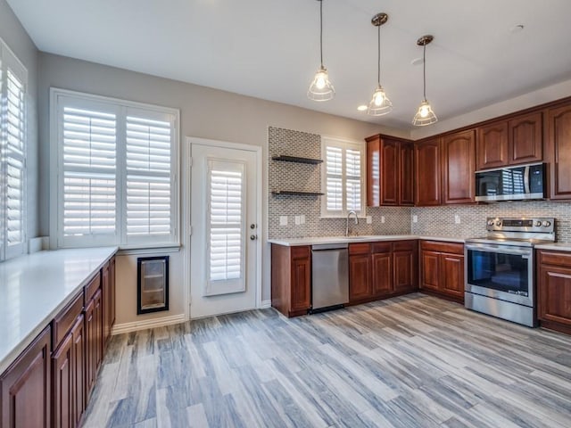 kitchen with open shelves, stainless steel appliances, decorative backsplash, and hanging light fixtures