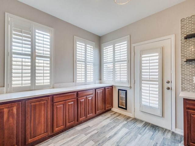 interior space with brown cabinetry, light countertops, and light wood finished floors