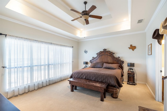 bedroom with baseboards, ornamental molding, a raised ceiling, and light colored carpet