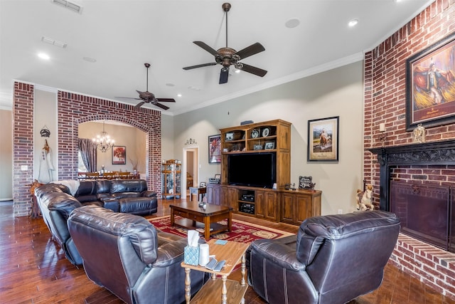 living area with arched walkways, ornamental molding, a fireplace, and visible vents