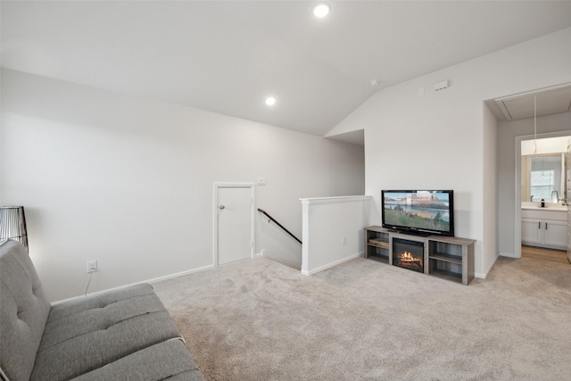 living area featuring carpet floors, attic access, and baseboards