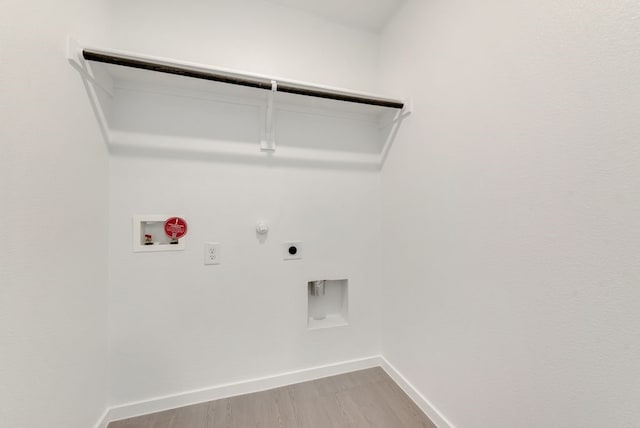 laundry area with laundry area, baseboards, hookup for a gas dryer, hookup for an electric dryer, and washer hookup