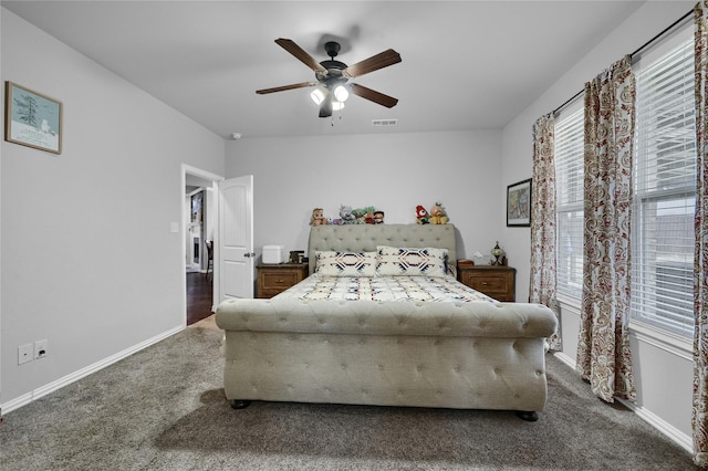 bedroom with carpet floors, a ceiling fan, visible vents, and baseboards